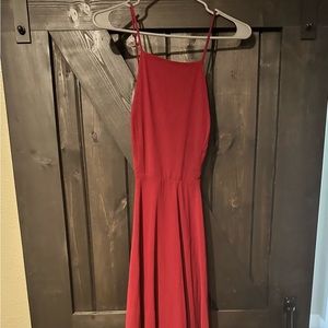 Formal wine colored cross back gown. Size Medium